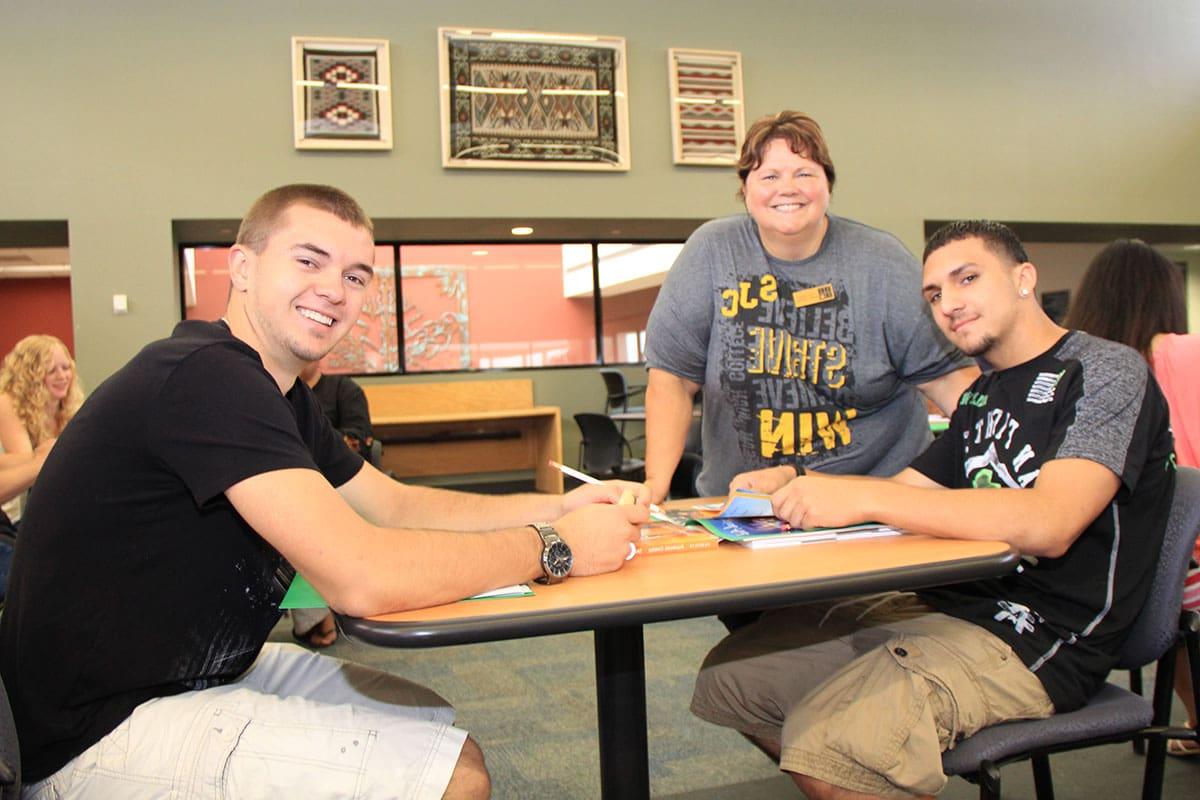 SJC students sitting at a table.